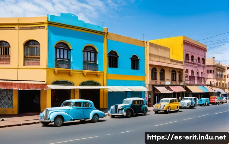 에리트레아의 건축적 걸작 - A vibrant street scene in Asmara, Eritrea, showcasing iconic Art Deco colonial buildings with pastel...